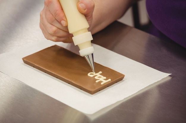 trabajador escribiendo feliz cumpleanos manga pastelera placa chocolate 107420 68583